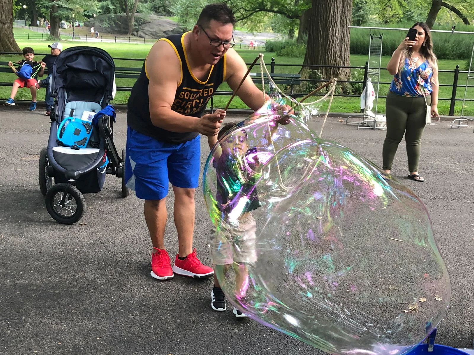 BubbleStix review — Sarah K., Bend, Oregon A father and child playing inside a giant BubbleStix bubble in Central Park